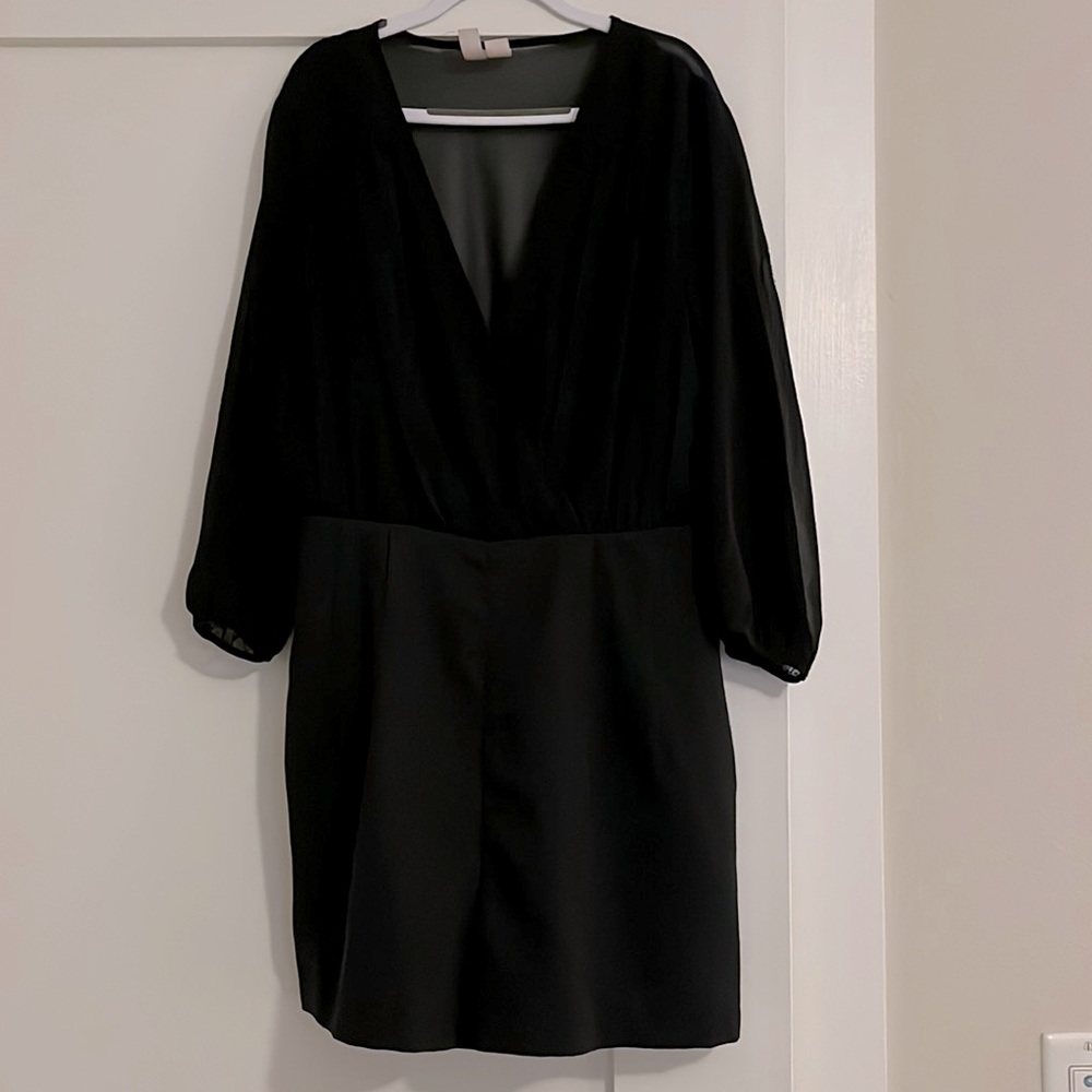 Black Romper, plunging V-neck chiffon bodice. Long tapered chiffon sleeves.